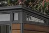 Close-up view of the corner of a garden shed, showing the roofline, windows, and wooden siding. Náhľad obrázku produktu
