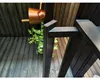 A close-up view of a wooden interior, possibly a sauna, with a copper bucket and green plant. Produktbild-Vorschau
