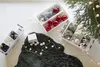 Christmas ornaments and lights are laid out on a dark rug next to storage boxes. Produktbild-Vorschau