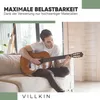 A man is playing a guitar while sitting on a couch. Náhled obrázku produktu