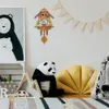 A child's room with a cuckoo clock, stuffed panda, and decorative items. Náhled obrázku produktu