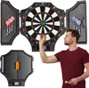A man is playing darts with an electronic dartboard that is open and mounted on a wall. The dartboard has a digital display and is surrounded by storage compartments for darts. Náhľad obrázku produktu