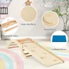 A wooden climbing arch and slide set for children, placed on a colorful rug in a room with decorative wall elements. Produktbild-Vorschau