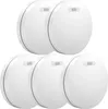 A group of five white smoke detectors are arranged in a staggered formation against a white background. Produktbild-Vorschau