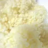 A close-up, detailed view of loose wool filling. Produktbild-Vorschau
