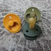 Three pacifiers are displayed on a textured surface. Náhled obrázku produktu