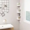 A white corner shelf unit with decorative items on a light gray wall next to a window. Produktbild-Vorschau