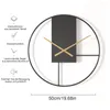A close-up of a modern wall clock with descriptive text and icons on the left side. Produktbild-Vorschau
