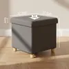 A gray storage ottoman with wooden legs is shown in a room with a wooden floor. Anteprima dell’immagine prodotto