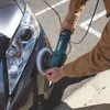 A person is using a Makita polisher on the front fender of a dark gray car. Podgląd zdjęcia produktu