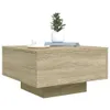 A modern coffee table with a wood grain finish, a white cup and saucer, and a small potted plant on top. Náhled obrázku produktu