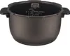 A close-up view of the interior of a rice cooker pot, showing measurement markings and branding. Voir les images du produit