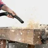 A person is using a vacuum cleaner hose to blow wood shavings off a workbench. Anteprima dell’immagine prodotto