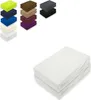 A stack of white fitted sheets is shown in the foreground, with a collage of various colored fitted sheets in the background. Produktbild-Vorschau