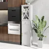 A kitchen or bathroom scene featuring a tall white storage cabinet next to built-in kitchen appliances and a large potted plant. Anteprima dell’immagine prodotto