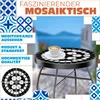 A mosaic bistro table with a cup of coffee on it, set against a blurred background of a seaside town. Produktbild-Vorschau