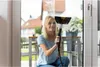 A woman is cleaning a window with a steam cleaner. Náhled obrázku produktu