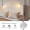 A bed with a headboard featuring integrated reading lights and a charging station. Produktbild-Vorschau