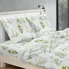 A bed with floral patterned bedding. Náhľad obrázku produktu