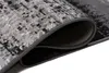 A close-up view of a rolled-up rug, showing its texture and edge. Produktbild-Vorschau