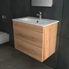 A modern bathroom vanity with a sink and faucet, set against a dark tiled wall. Produktbild-Vorschau