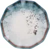 A top-down view of a single, irregularly shaped plate with a marbled blue and white glaze and a brown rim. Voir les images du produit