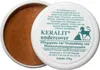 A white tub of Keralit Undercover Pflegepaste, with the lid open showing the brown paste inside. The lid has text and a logo. Produktbild-Vorschau