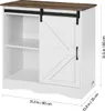 A white and brown cabinet with a sliding barn door and open shelving. Produktbild-Vorschau