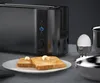 A toaster with toast and an egg in an egg cup. Anteprima dell’immagine prodotto