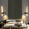A bedroom scene with a bed and two wall lamps. Produktbild-Vorschau