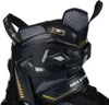 A close-up view of the top part of a black and gold inline skate. Náhled obrázku produktu