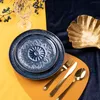 A table setting with plates, cutlery, and a decorative bowl. Podgląd zdjęcia produktu