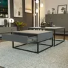 A modern living room with a coffee table, a side table, a console, and framed art on the wall. Produktbild-Vorschau