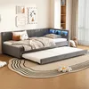 A modern bedroom with a gray upholstered daybed with a pull-out trundle bed. The daybed has built-in LED lighting in the headboard and is adorned with decorative pillows and blankets. A round rug with a wavy pattern is placed in front of the bed. Podgląd zdjęcia produktu