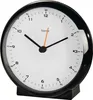 A close-up studio shot of a black alarm clock with a white face and black hands. Produktbild-Vorschau