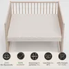 A crib with a fitted sheet on the mattress, surrounded by informational icons. Produktbild-Vorschau
