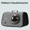 A gray pet carrier with a clear bubble window is shown against a light gray background. Produktbild-Vorschau