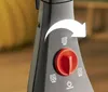 Close-up of a control dial and icons on a black appliance. Produktbild-Vorschau
