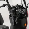 A close-up view of the handlebars and dashboard of a red and black three-wheeled scooter. Produktbild-Vorschau