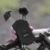 A hand holding a black Vayox phone mount attached to a bicycle handlebar. Anteprima dell’immagine prodotto