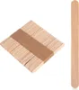 A stack of wooden popsicle sticks and one individual stick on a white background. Produktbild-Vorschau
