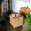 A woven basket filled with firewood is placed next to a modern wood-burning stove. Anteprima dell’immagine prodotto