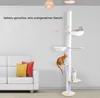 A multi-tiered cat tree with several levels and hanging hammocks, featuring three cats. A white sofa with two decorative pillows is visible in the background. Produktbild-Vorschau