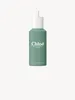 A product shot of a green perfume bottle with a white cap and applicator. Anteprima dell’immagine prodotto