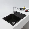 A black kitchen sink with a chrome faucet is shown on a white countertop. Podgląd zdjęcia produktu