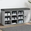 A shoe bench with multiple compartments and a cushioned top, filled with various shoes. Anteprima dell’immagine prodotto