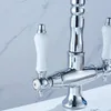 A close-up view of a kitchen faucet with ceramic handles. Náhled obrázku produktu