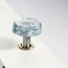A close-up of a screw with a clear plastic cap and a metal washer, attached to a white surface. Náhľad obrázku produktu