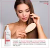 A woman is shown brushing her hair while holding a bottle of Seboradin Forte shampoo. Podgląd zdjęcia produktu