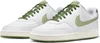 A pair of white Nike Court Vision Low sneakers with green accents and laces, presented on a white background. Produktbild-Vorschau